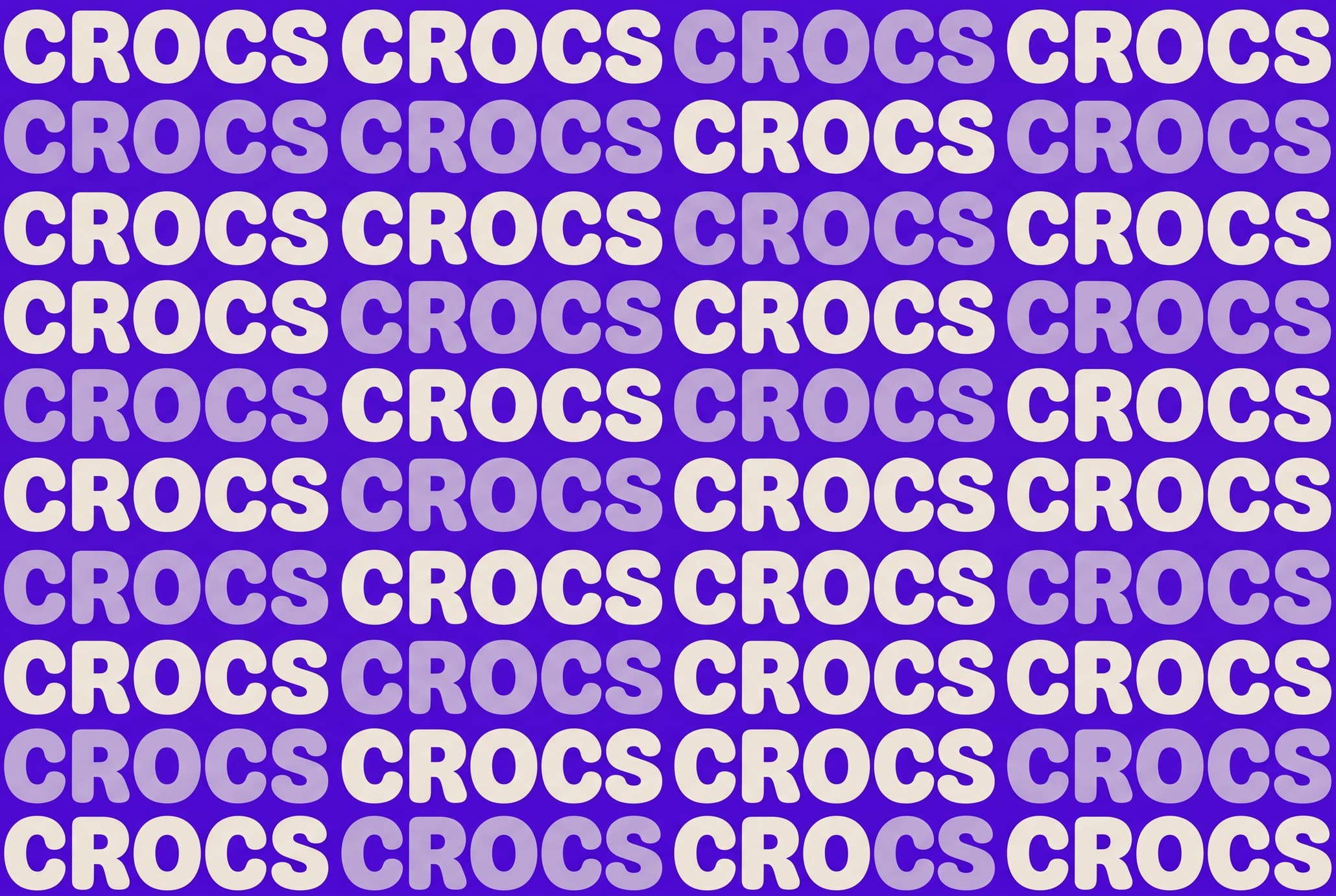 Flat half-drop pattern of the cream CROCS wordmark, low contrast on ultraviolet.