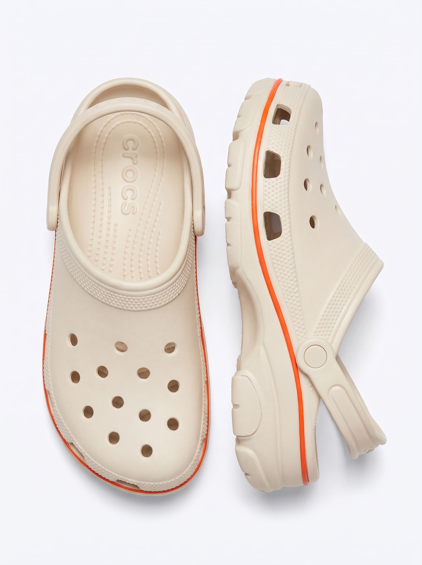 Top-down pair of cream moulded clogs on white, wordmark moulded into the footbed.