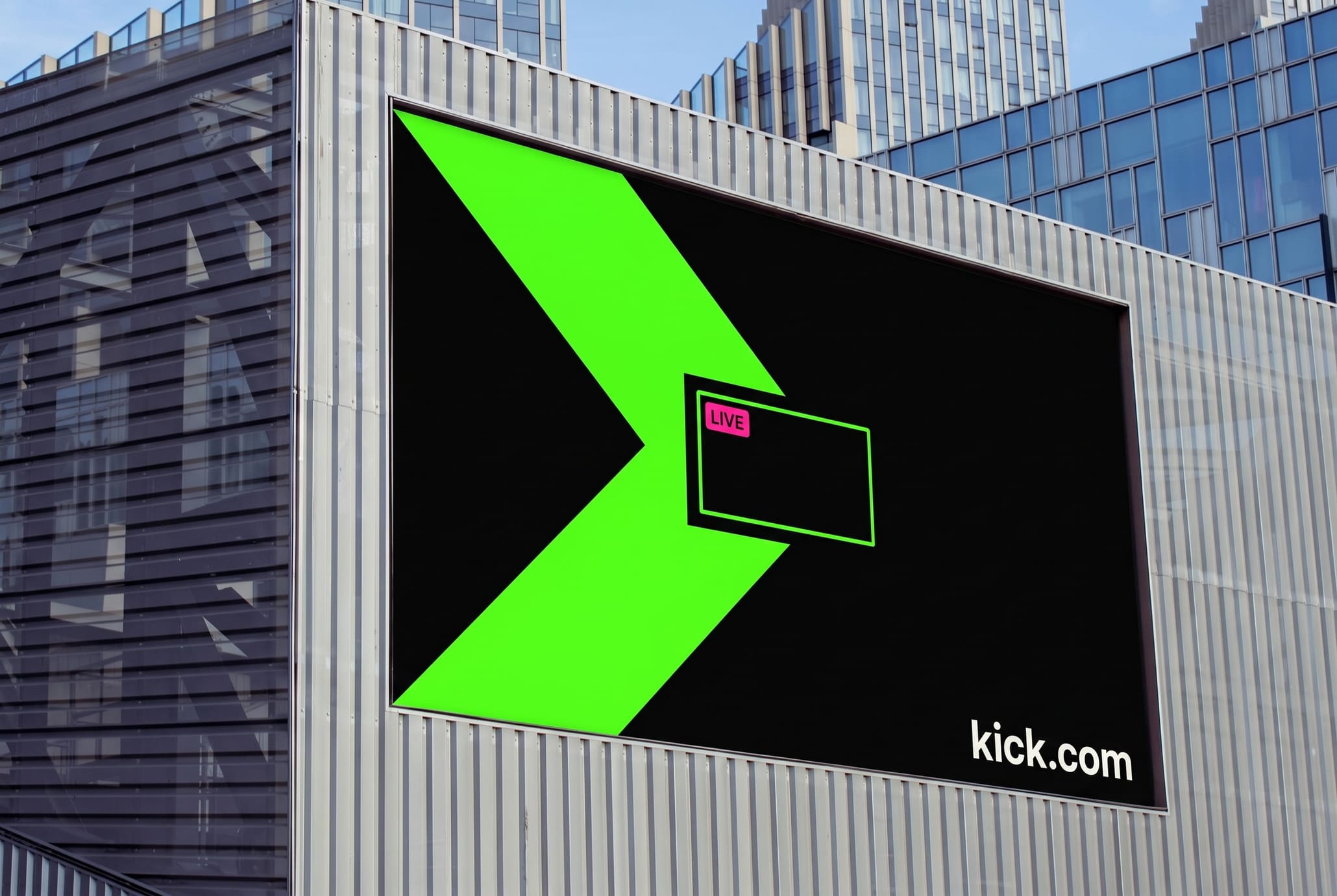 Large LED billboard on a metal façade showing a grid of black thumbnails with one green live tile.