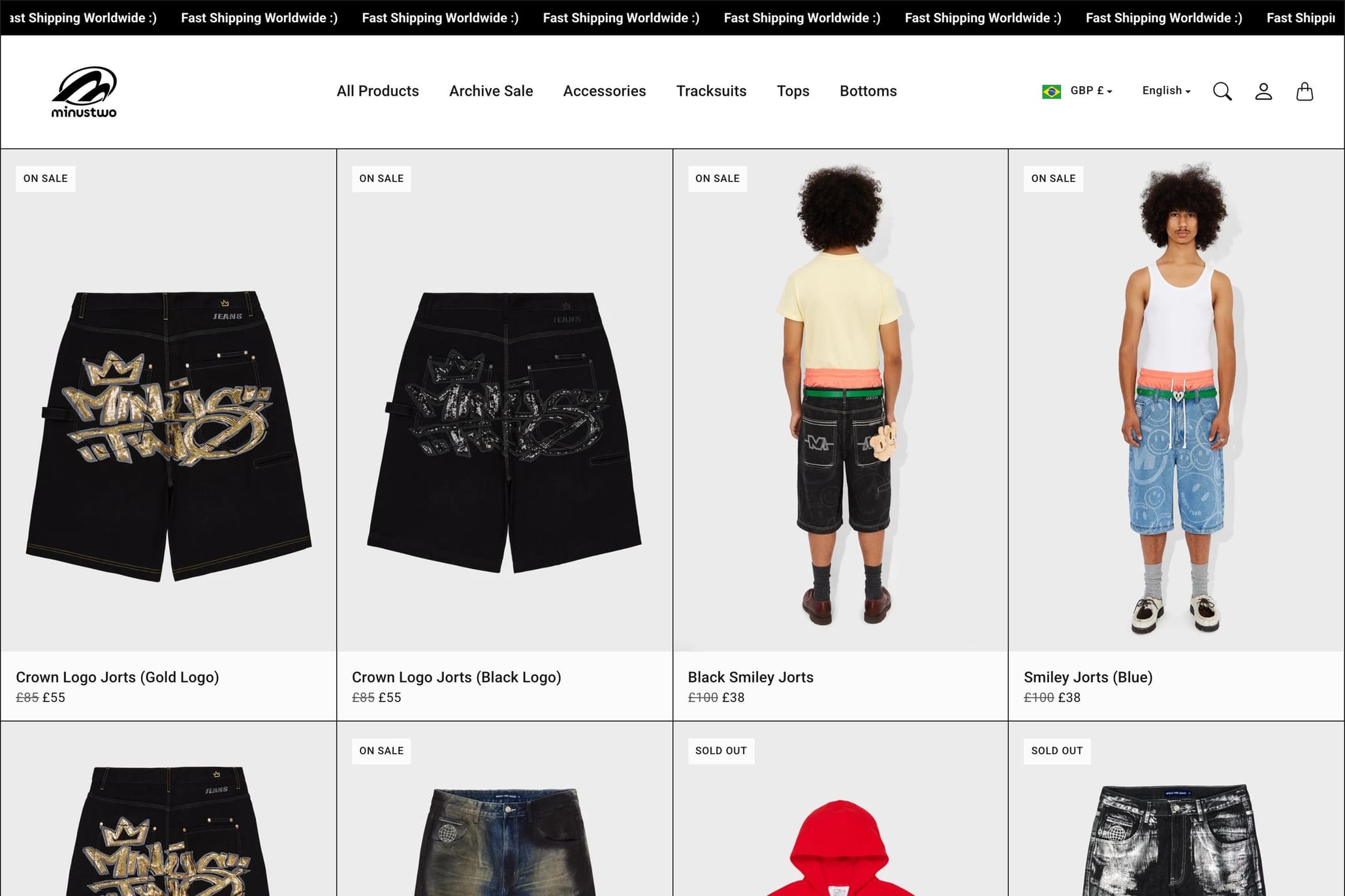 The Minus Two homepage: an announcement marquee above a dense grid of product photography