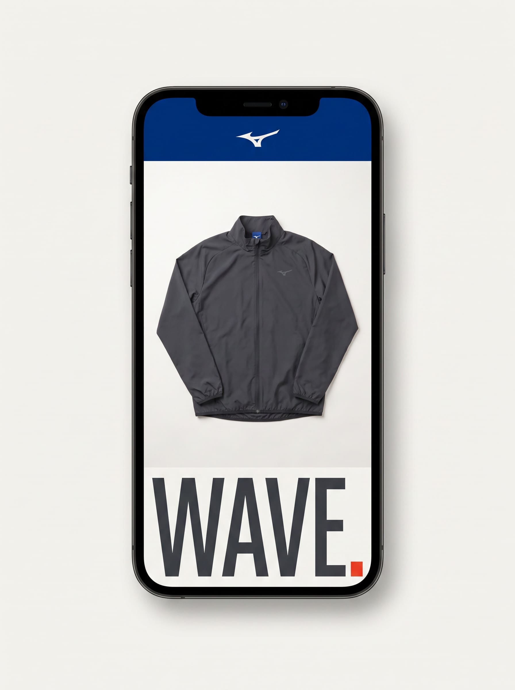 Phone on a bone-white surface showing a Mizuno product screen with a flat-laid graphite running jacket.
