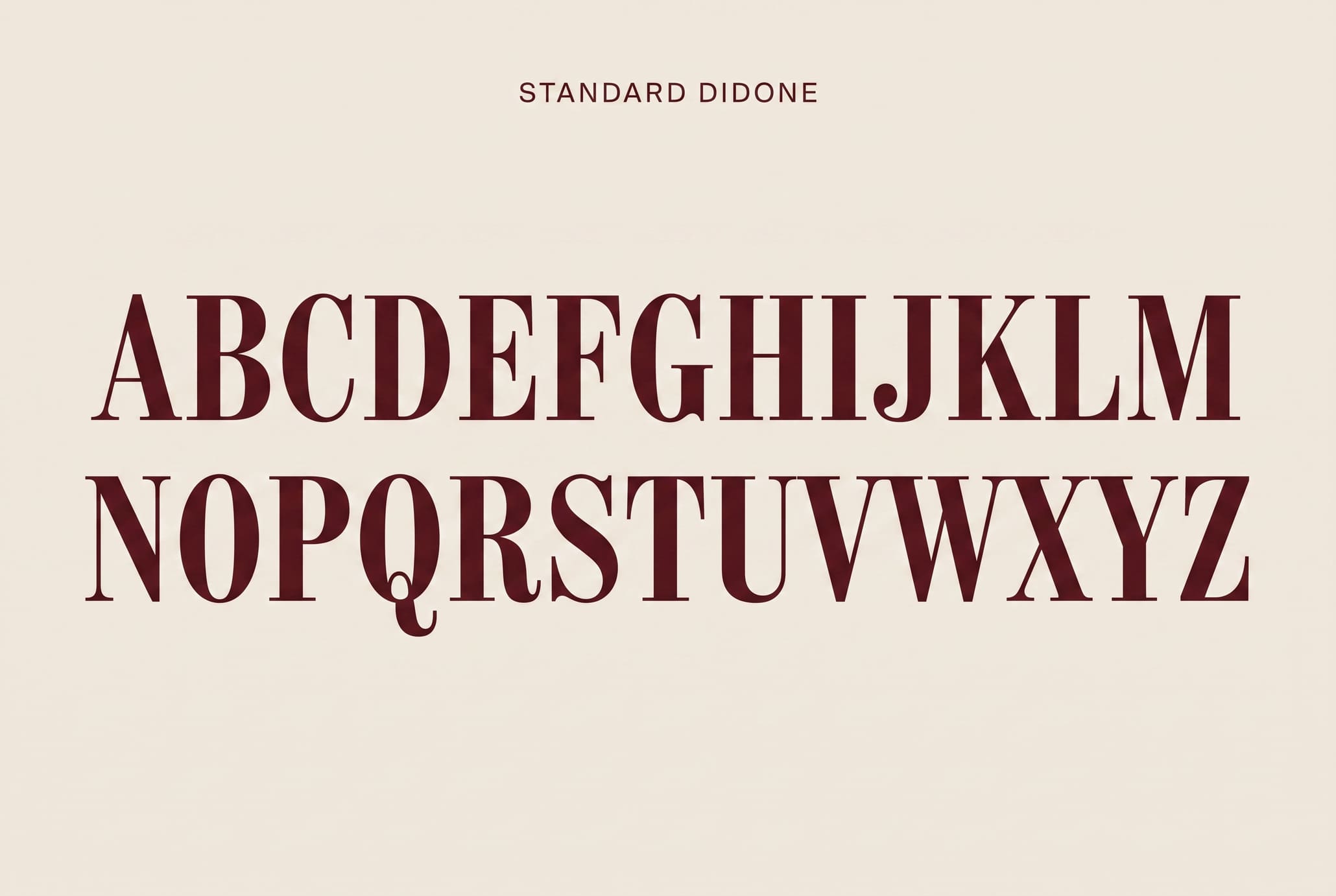 Flat cream type specimen showing the label STANDARD DIDONE above two rows of oxblood didone capitals, A to M and N to Z.